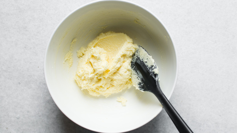 Creamed butter and sugar with a silicone spatula in a mixing bowl