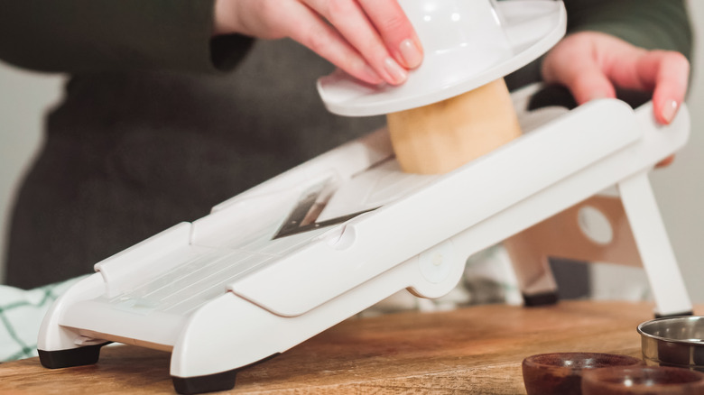 Slicing potatoes with mandoline