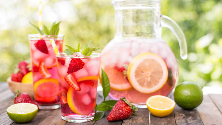 pitcher and glasses of mixed drink with fruit