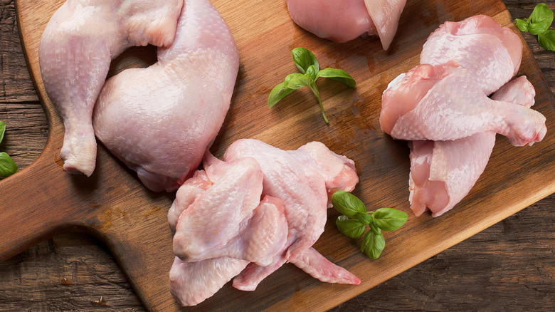 Raw chicken meat on cutting board