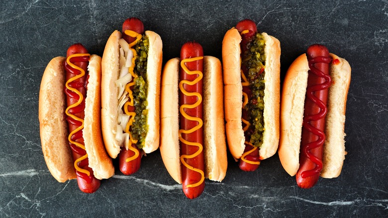 top down view of hot dogs  on dark surface