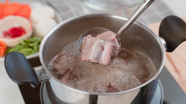 pot of boiling pork stock