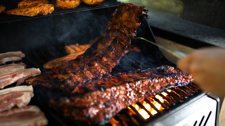 barbecue ribs lifted off grill