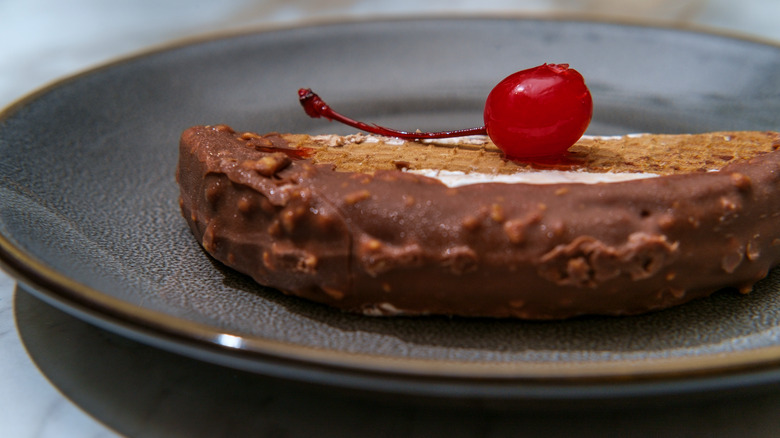 dessert taco garnished with cherry