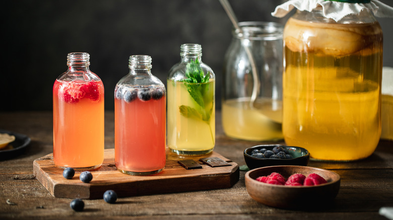 Bottles of homemade kombucha with different fruit and herbs