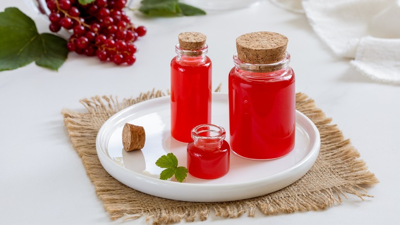 red currant simple syrup in small jars