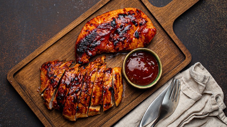 oven barbecue chicken on wooden cutting board