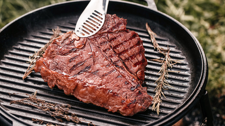 Porterhouse steak resting on grill