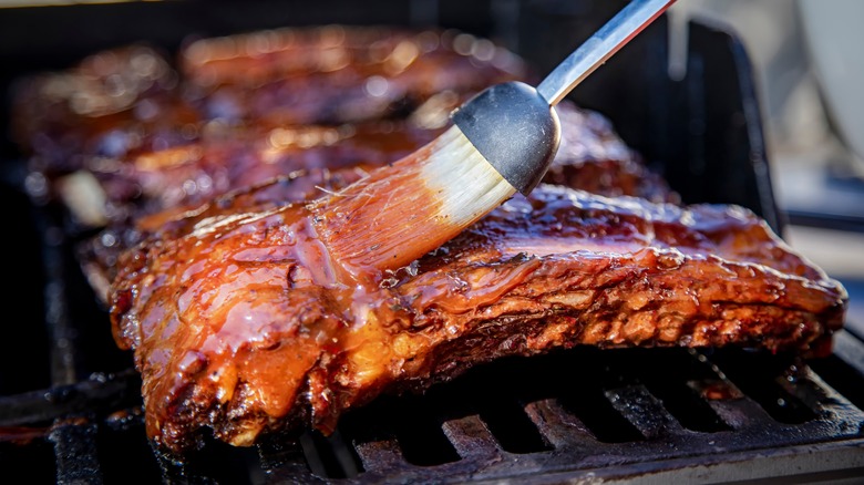 basting ribs on a grill