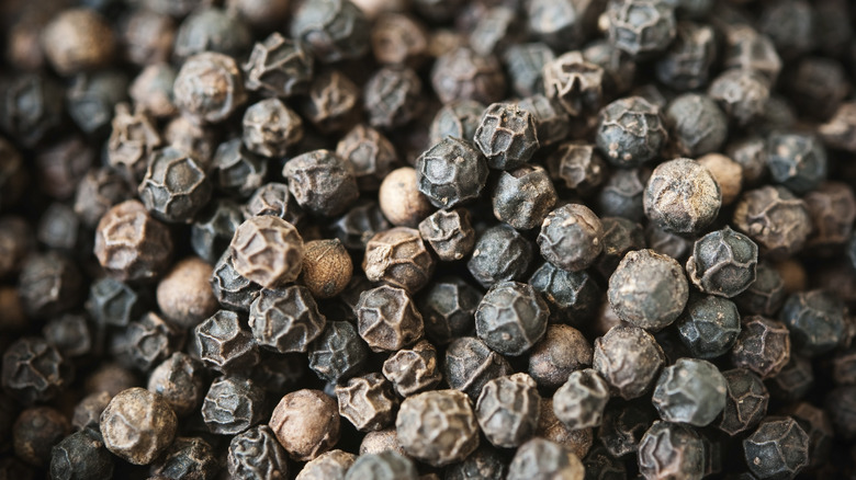 close up of black peppercorns