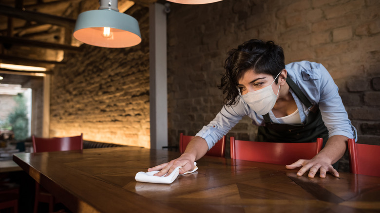 Server cleaning a table