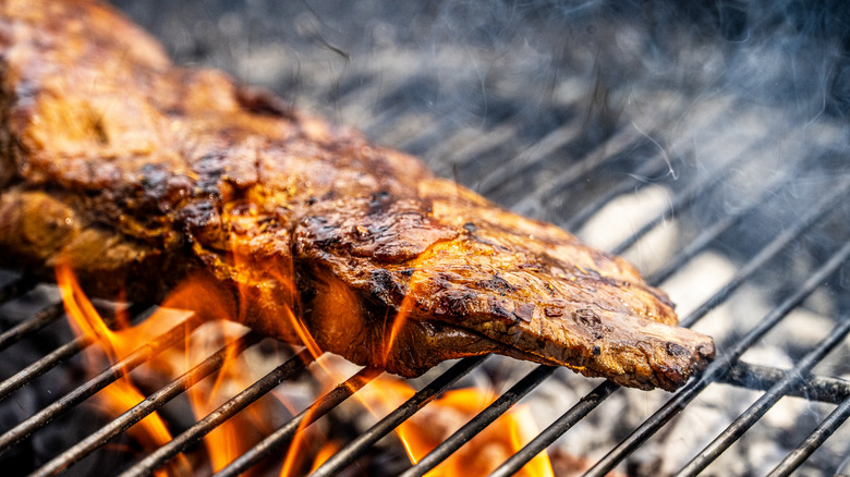 meat roasting over charcoal grill