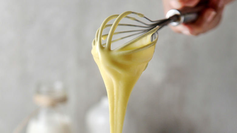 Whisk covered in cake batter