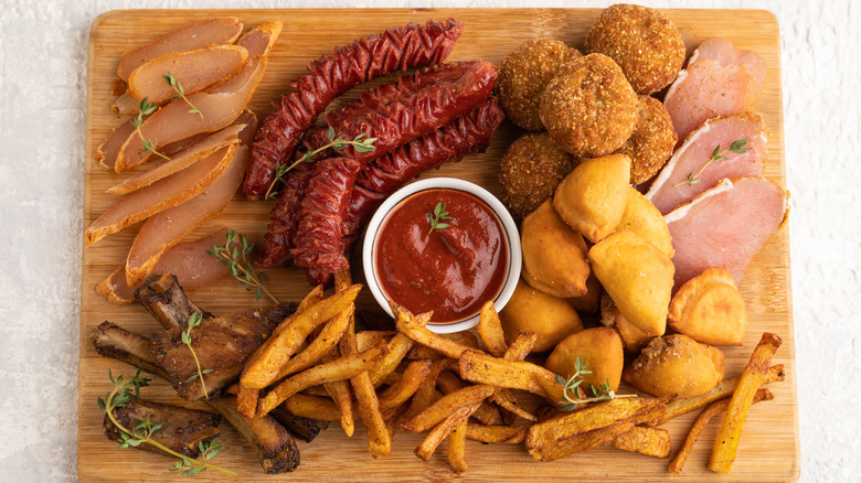 Pre-made fries and meat on charcuterie board