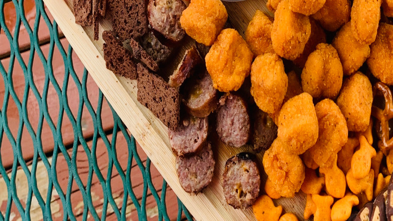 Kid charcuterie board with white dip, carrots, bread, and chicken