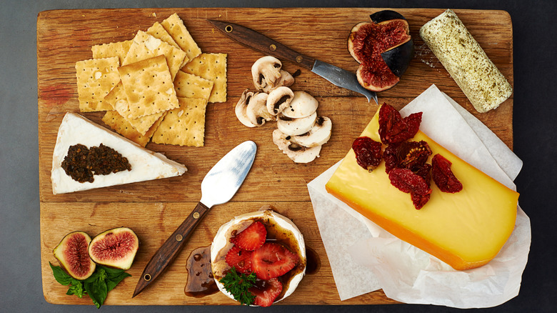 Basic charcuterie board with figs, cheese, crackers, and mushrooms