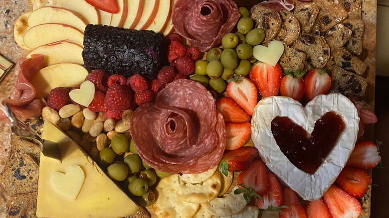 Valentine's charcuterie board with slices of cheese