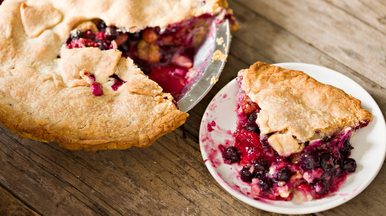 berry pie with a slice on a plate