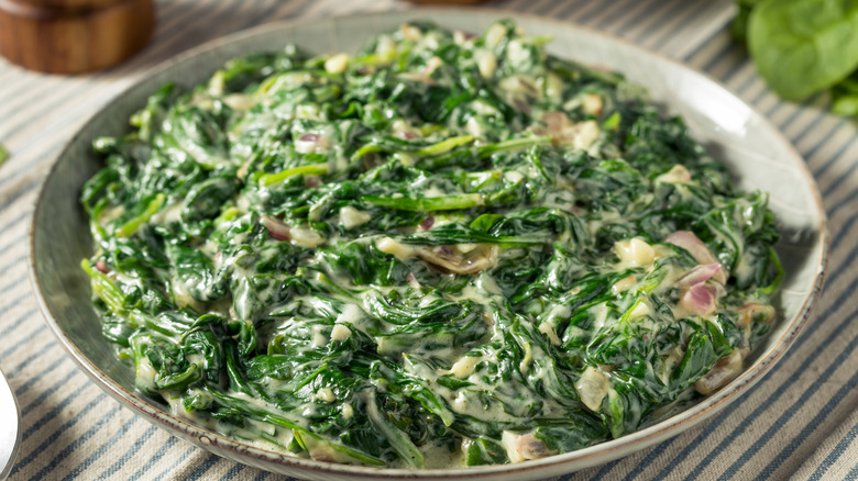 Homemade creamed spinach in an off-white dish