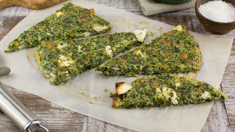 keto flatbread with herbs on parchment paper