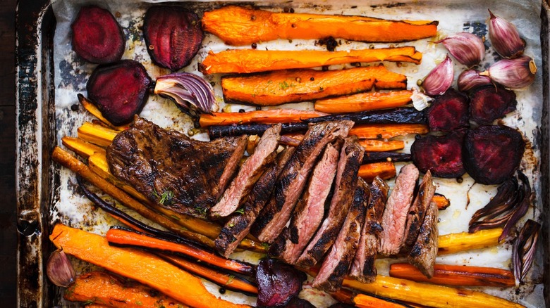 steak and roasted greens on sheet pan