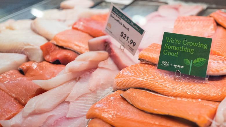 A display of fresh fish with labels is at the grocery store.