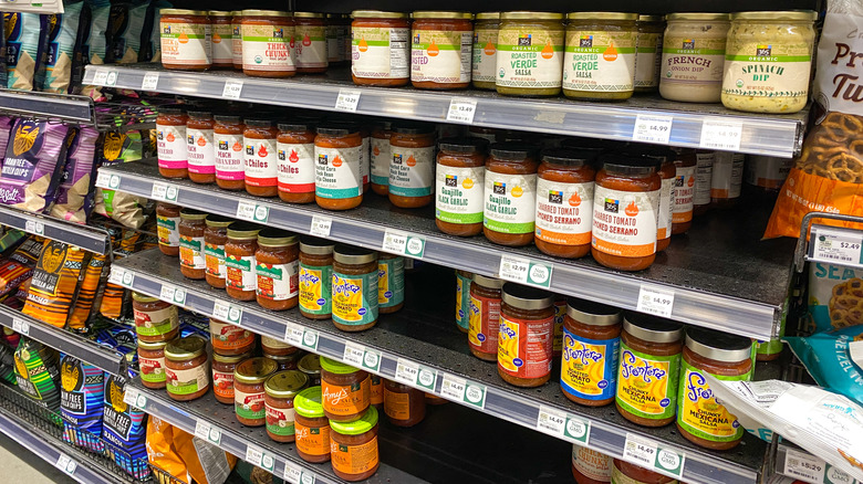 Jars of salsa are displayed on Whole Foods grocery shelves.