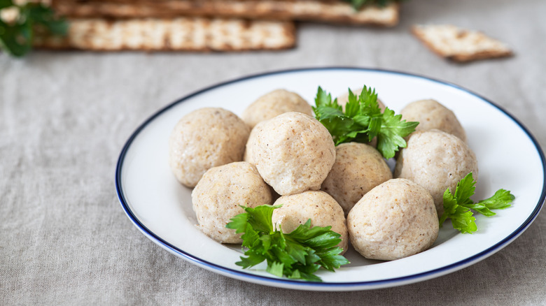 Homemade matzo balls on a plate after being shaped