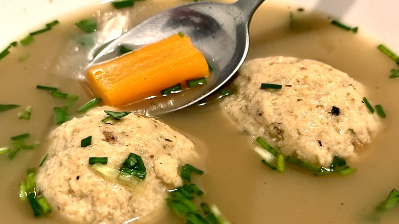 Close-up of matzo balls poaching in broth