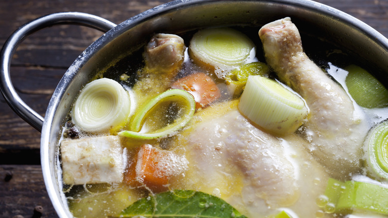Chicken and vegetables in a soup pot ready to be cooked