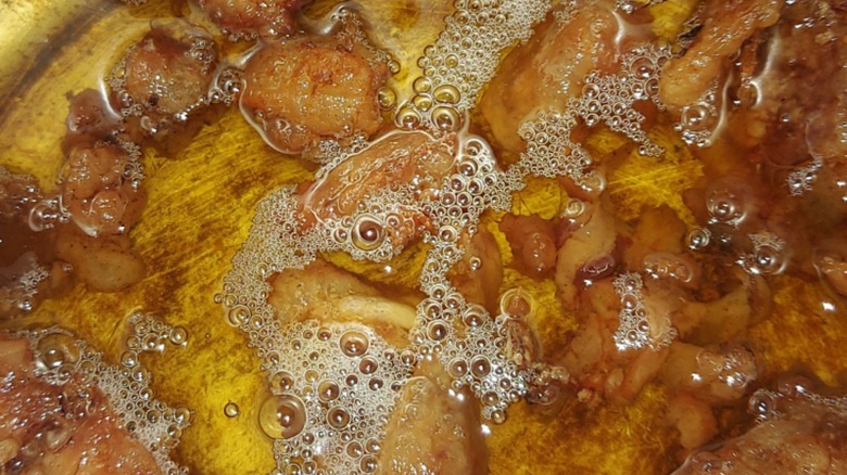 Close-up of some chicken fat being rendered into schmaltz