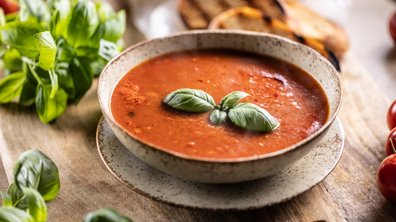 Tomato soup in bowl with fresh basil