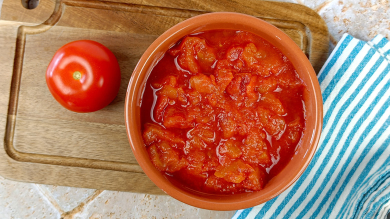 Crushed tomatoes on cutting board