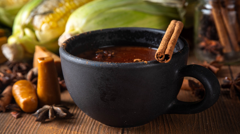 Hot chocolate with cinnamon stick, sugar, and corn