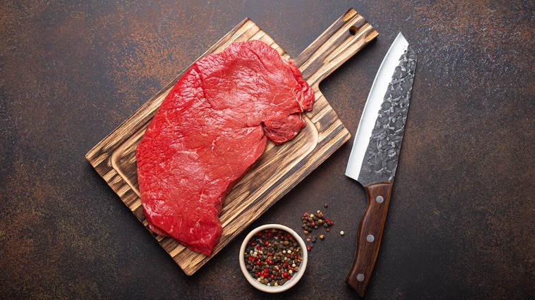 Top round steak on cutting board