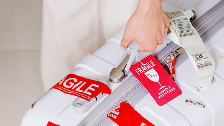 hand suitcase with fragile sticker