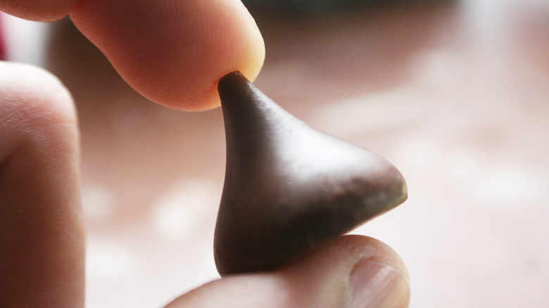 Hershey's Kiss between fingers