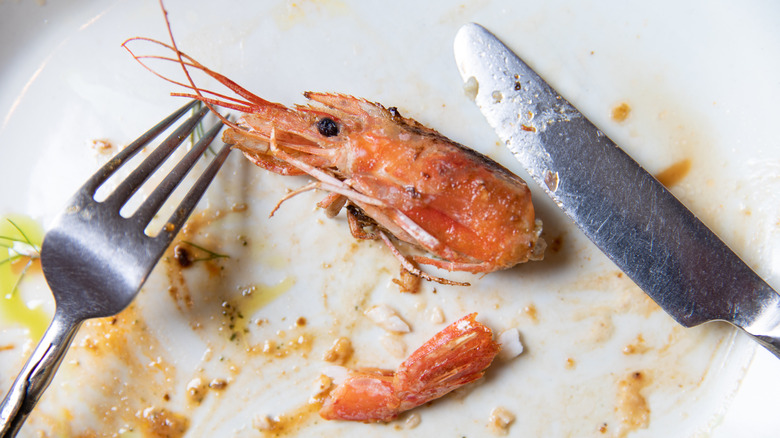 Shrimp head on dirty plate