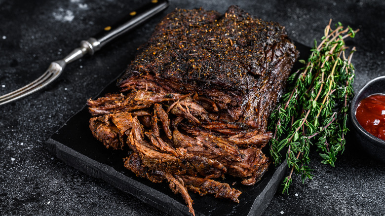 platter of smoked chuck roast with some meat shredded