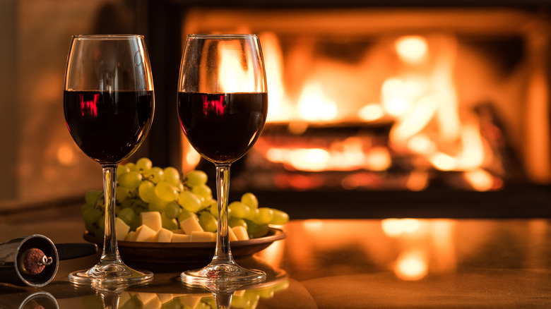 red wine glasses and fireplace