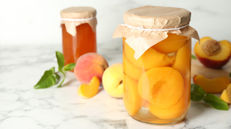 jars of pickled peaches on countertop