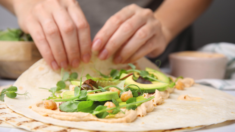 Rolling a filled tortilla