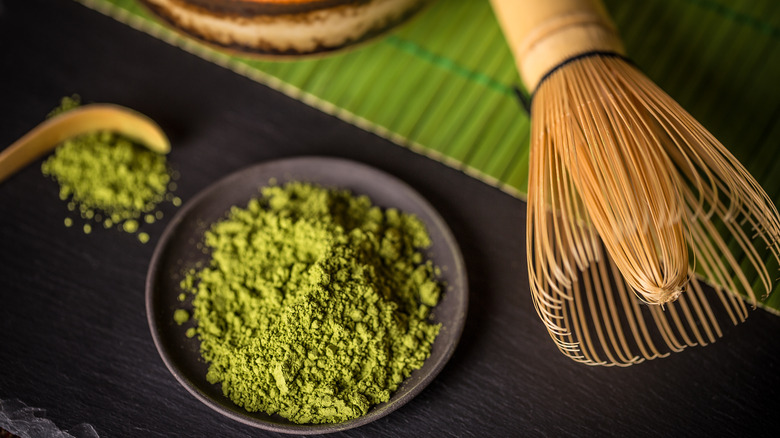 Plate of matcha powder and whisk
