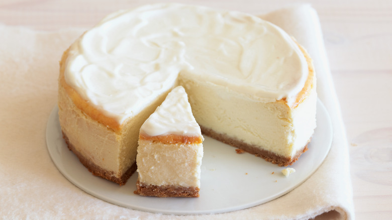 Loaf of cheesecake on plate.