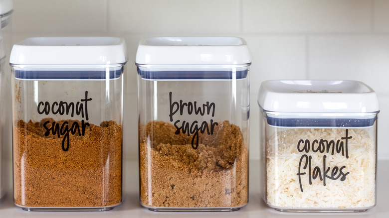 Storage containers of coconut sugar, coconut flakes, brown sugar