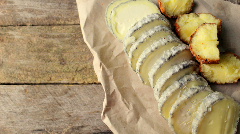 sliced goat cheese log on parchment paper