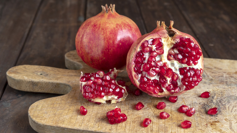 pomegranate cut on wooden board 