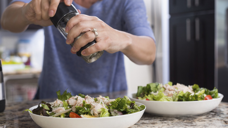 Grinding pepper on a salad