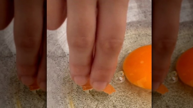 removing eggshell with fingers