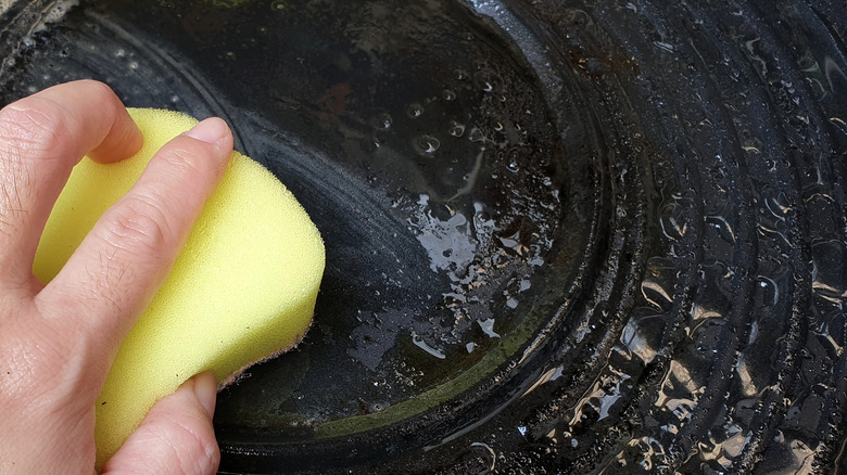 Scrubbing cast iron with sponge